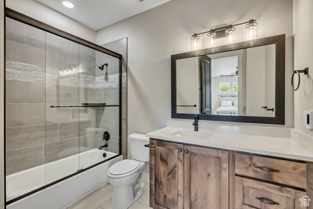 Full bath featuring combined bath / shower with glass door, vanity, ensuite bath, and tile patterned floors