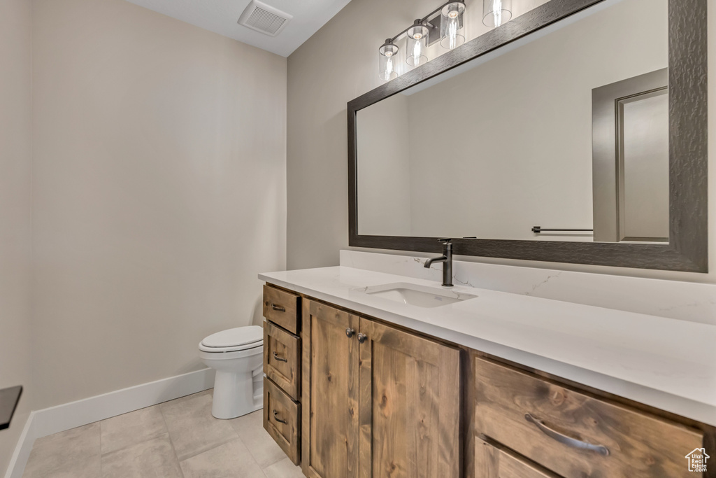 Bathroom featuring baseboards and vanity