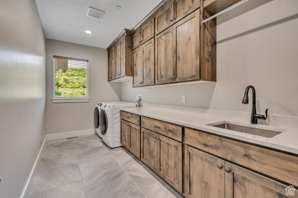 Washroom featuring cabinet space, light marble finish floors, separate washer and dryer, and recessed lighting