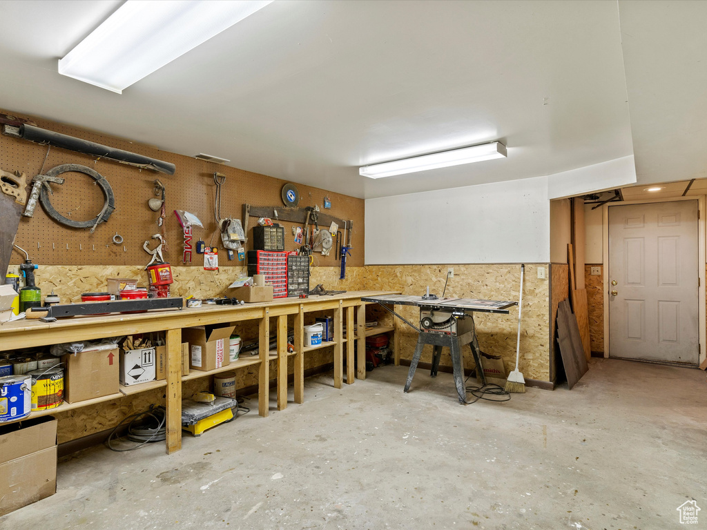 Miscellaneous room with a workshop area and unfinished concrete floors