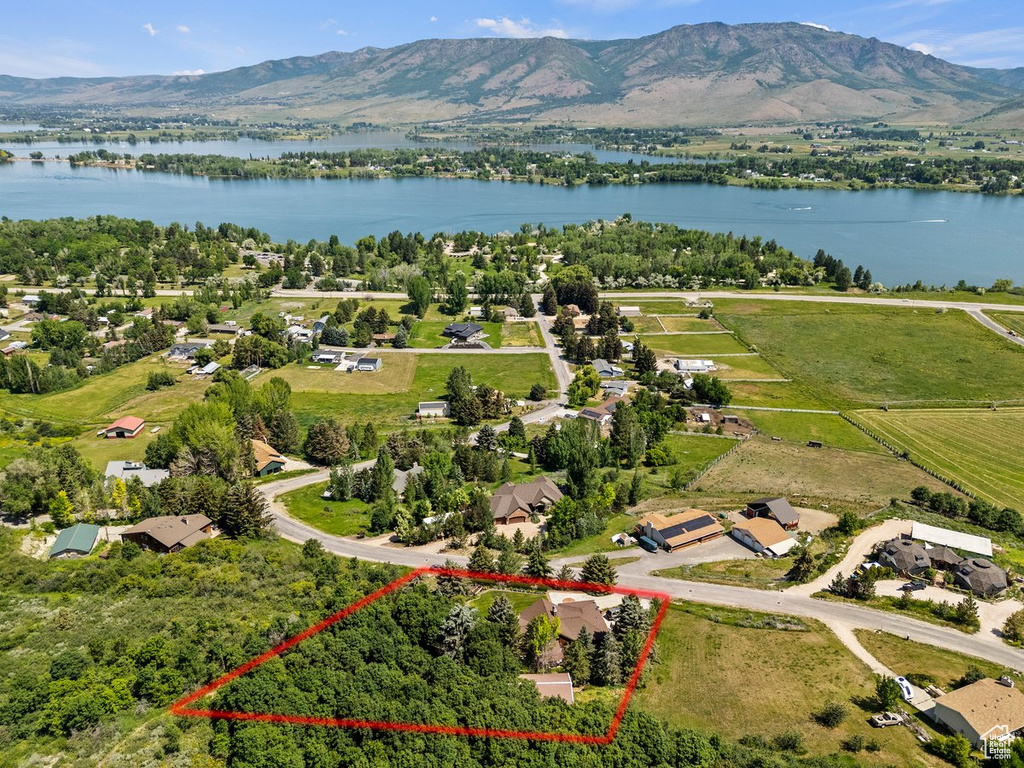 Aerial view of property\'s location featuring property boundaries highlighted and a water and mountain view