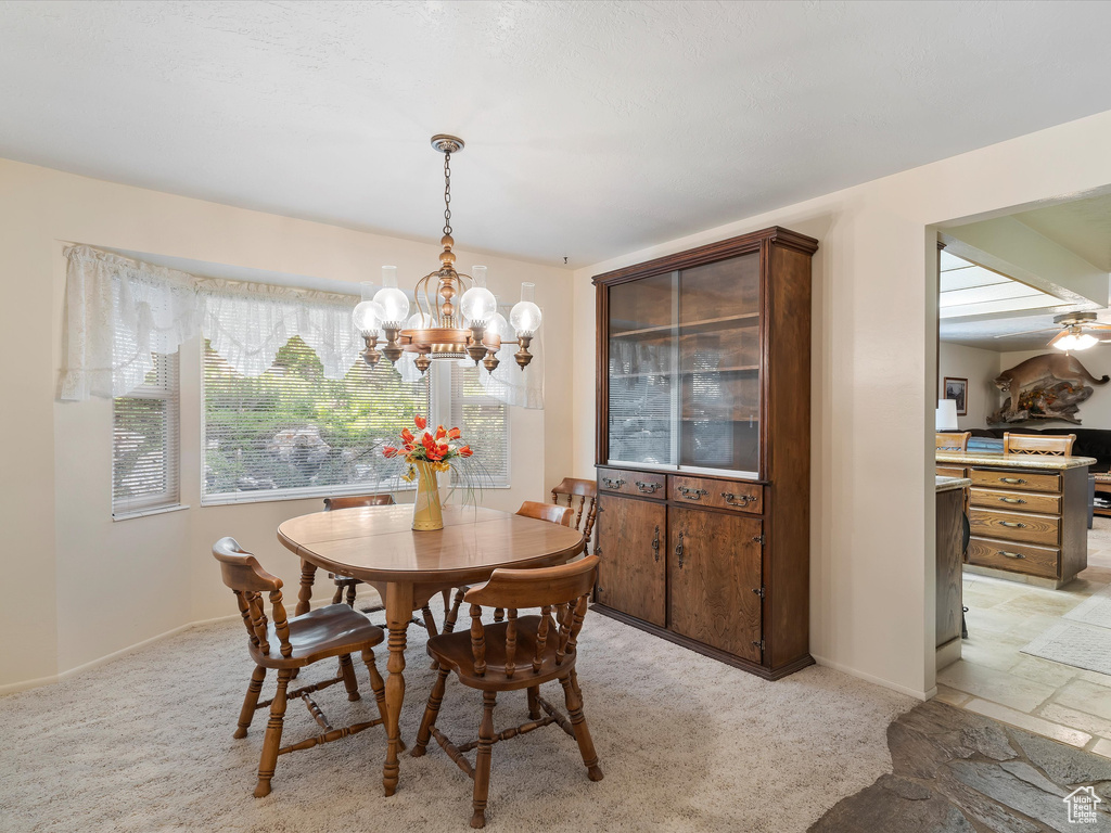 Dining room with a chandelier and light colored carpet