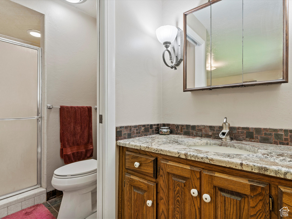 Bathroom featuring vanity, a stall shower, and tile patterned flooring