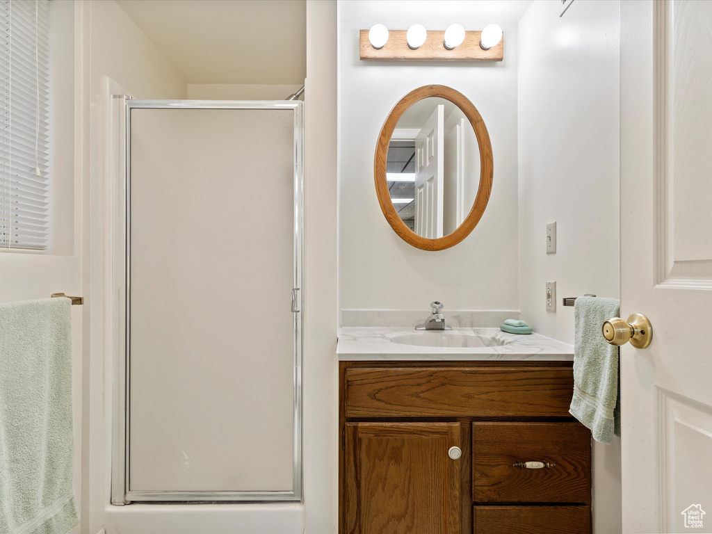 Bathroom with vanity and a shower stall