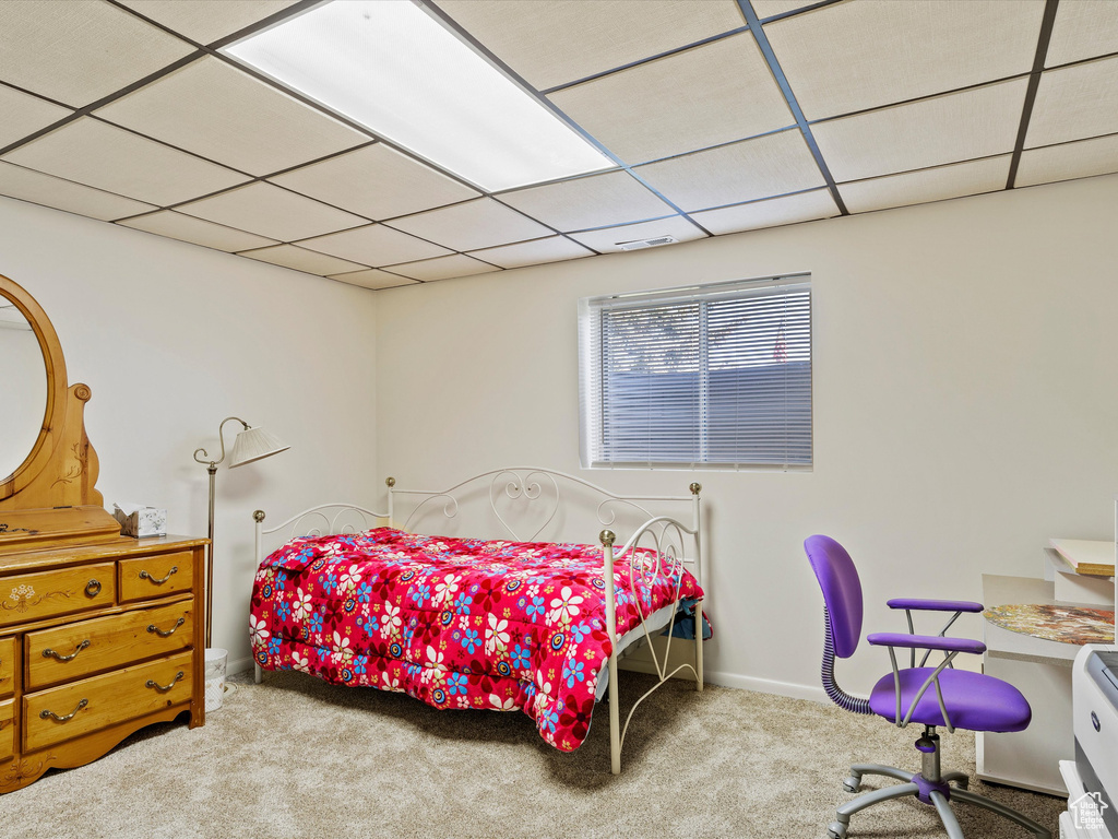 Bedroom with carpet flooring and a paneled ceiling