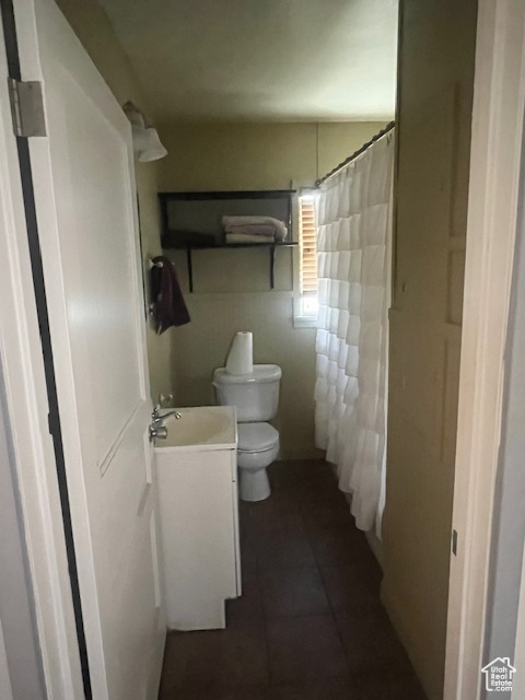Bathroom with vanity, tile patterned floors, and a shower with shower curtain