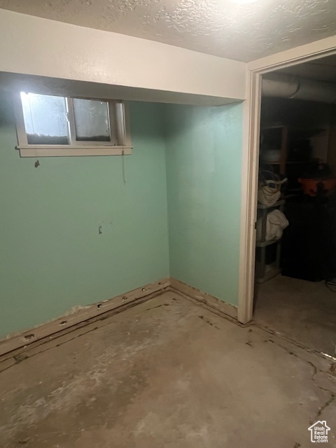 Finished below grade area featuring a textured ceiling