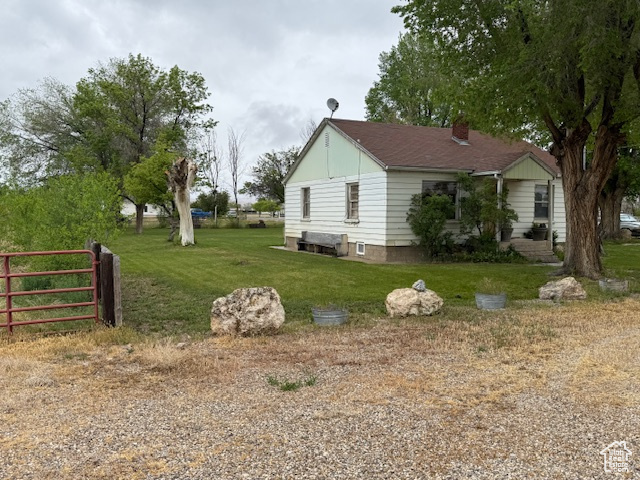 View of property exterior featuring a chimney