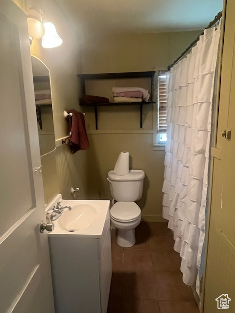 Bathroom featuring vanity, tile patterned flooring, and a shower with shower curtain
