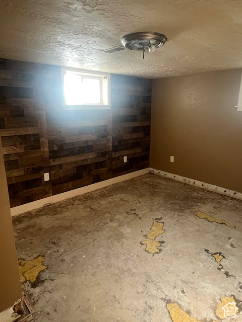 Unfurnished room with a textured ceiling