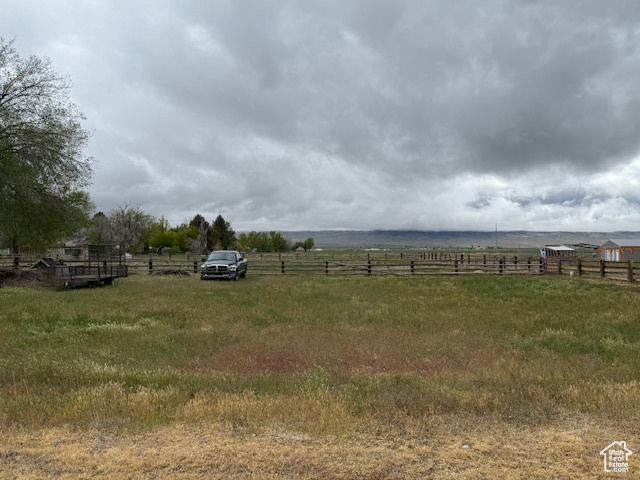View of yard with a rural view