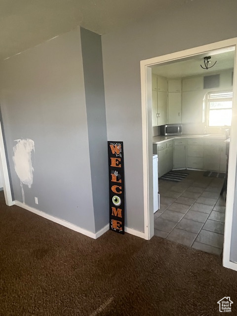 Unfurnished room featuring carpet flooring and baseboards