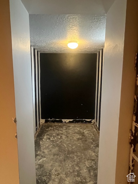 Hallway with a textured ceiling