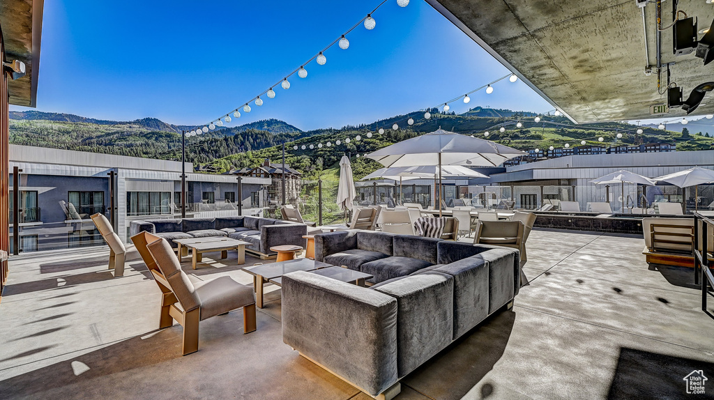 View of patio / terrace with an outdoor living space with a fire pit and a mountain view