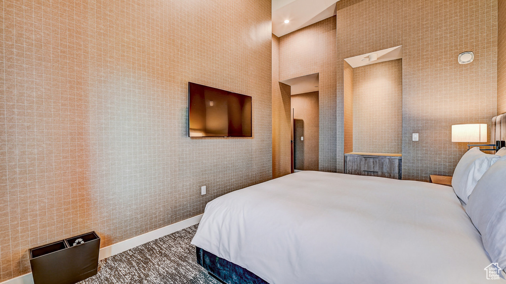 Bedroom with tile walls