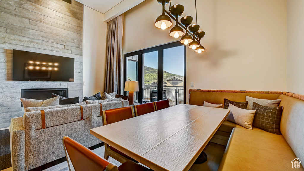 Dining area featuring a high ceiling and a large fireplace