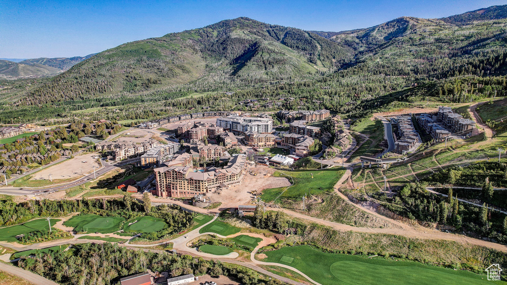 Aerial view of property\'s location featuring a mountainous background and a local golf course