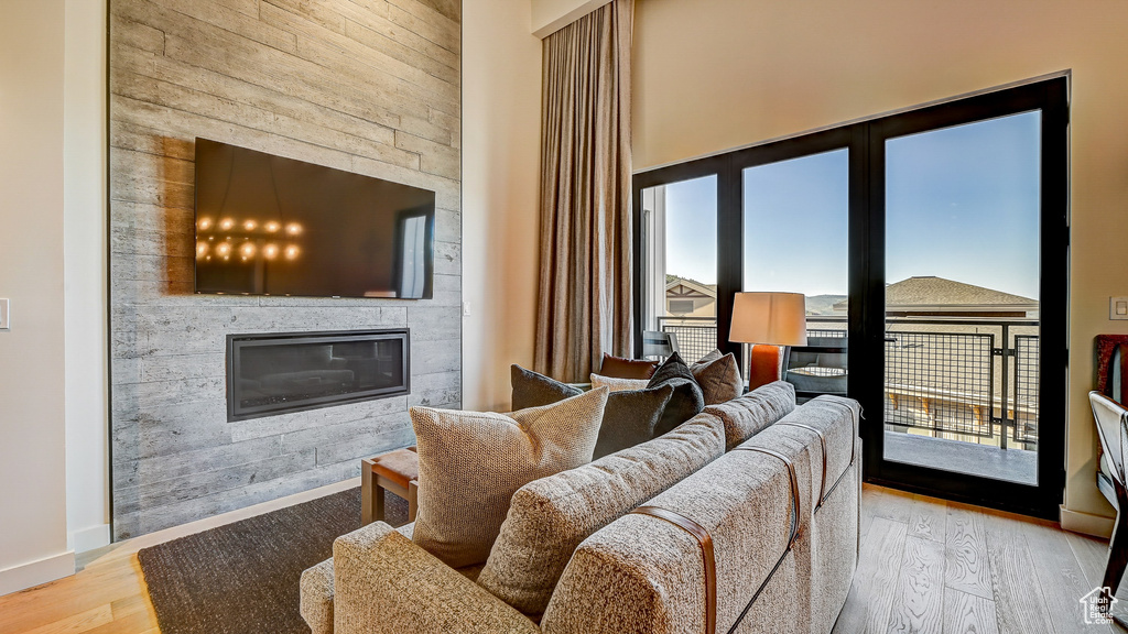 Living room featuring a large fireplace and wood finished floors