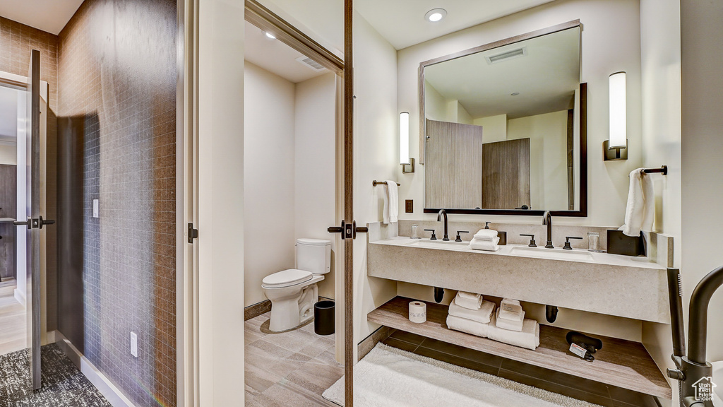 Full bath featuring toilet and vanity