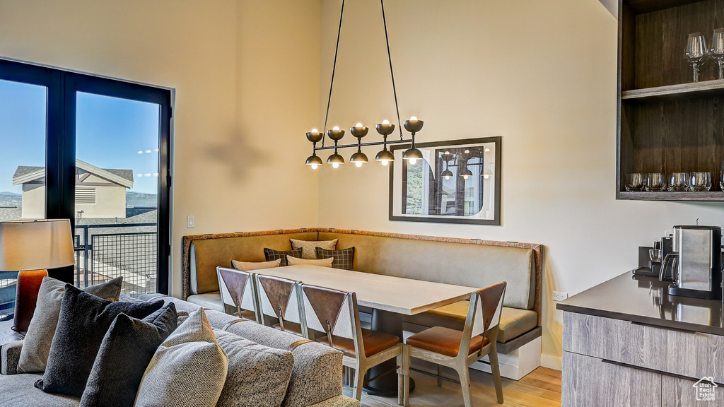 Dining room featuring wood finished floors and a towering ceiling