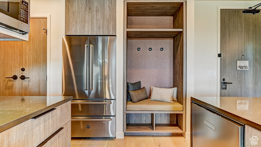 Kitchen with stainless steel appliances, modern cabinets, and light wood-type flooring