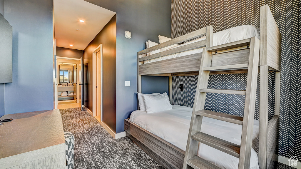 Bedroom with carpet, wallpapered walls, an accent wall, and recessed lighting