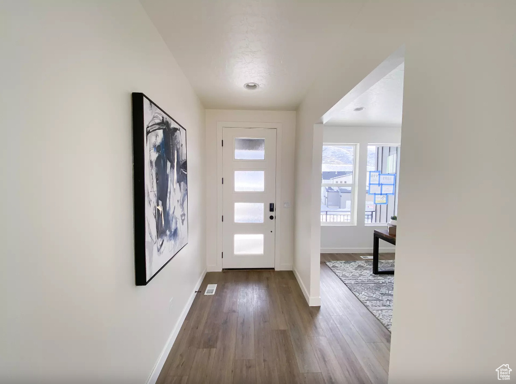Foyer featuring baseboards and dark wood finished floors
