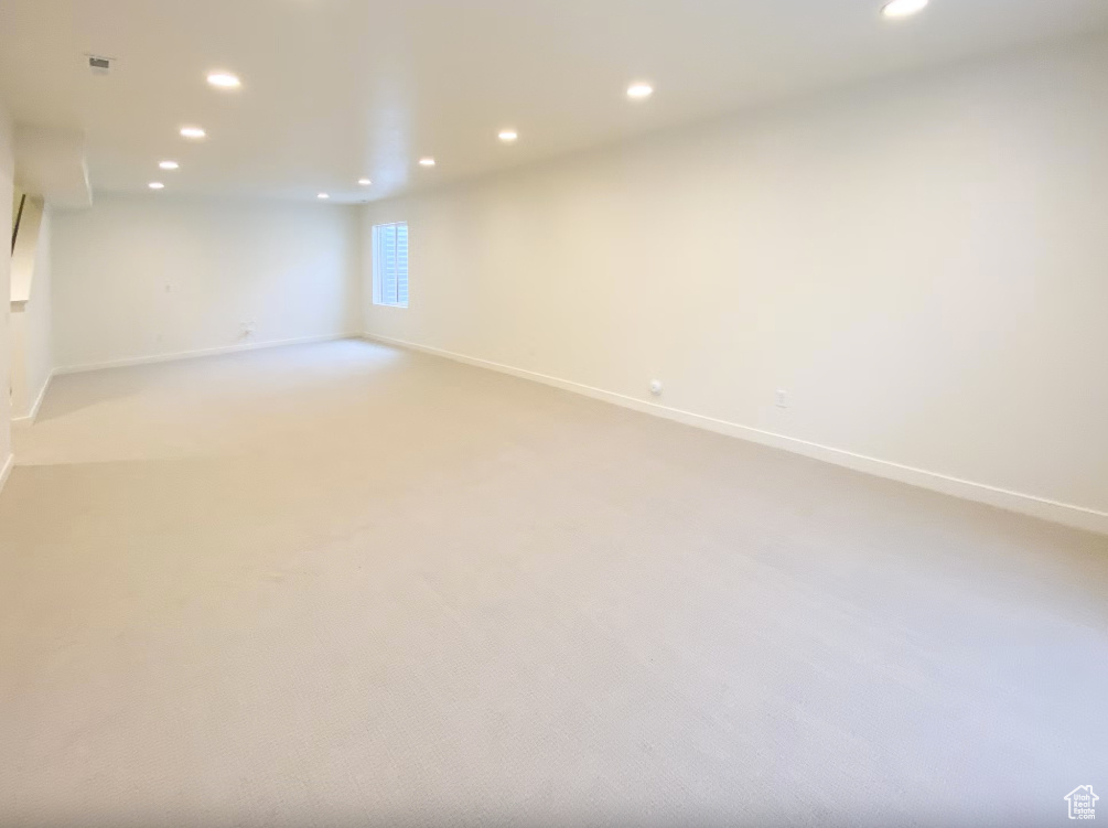 Unfurnished room featuring recessed lighting and light colored carpet