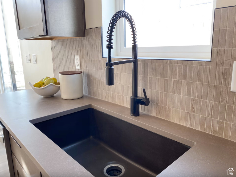 Kitchen view of a sink and decorative backsplash