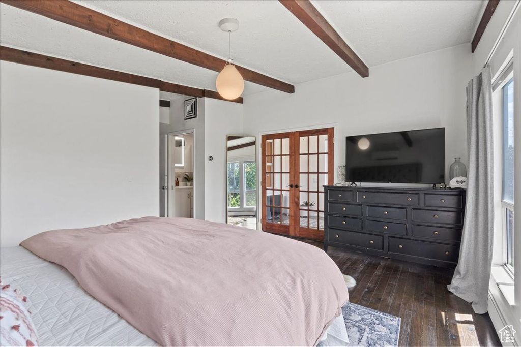 Bedroom featuring french doors, beam ceiling, and dark wood-type flooring