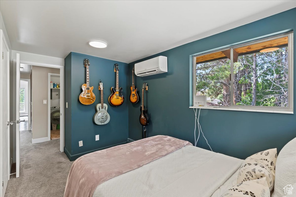 Bedroom with a wall unit AC and carpet flooring