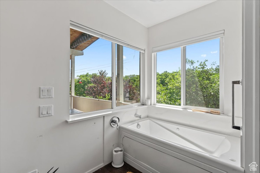 Bathroom with a bath and healthy amount of natural light