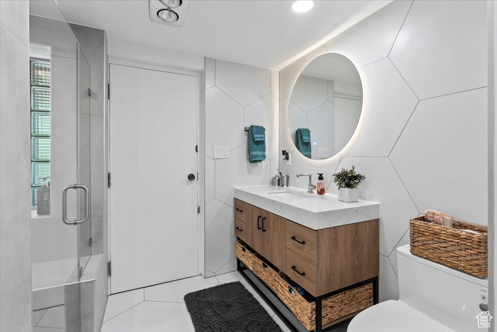 Bathroom featuring vanity, a stall shower, and tile patterned floors