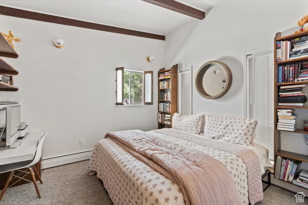 Carpeted bedroom featuring baseboard heating, beamed ceiling, and an office area