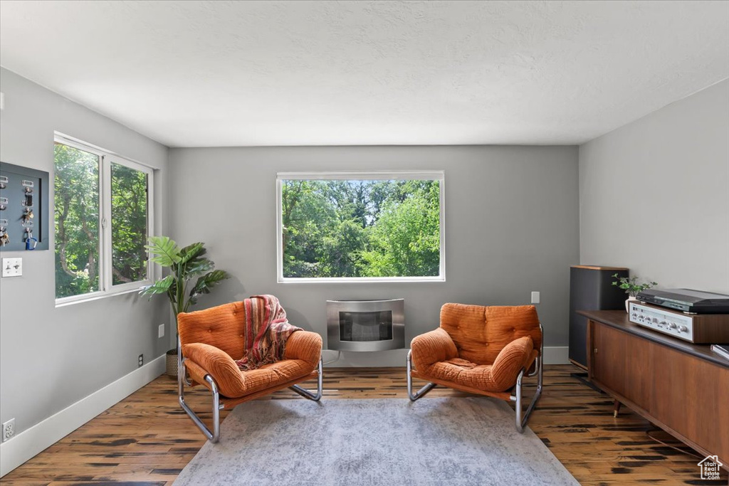 Living area featuring wood finished floors and heating unit