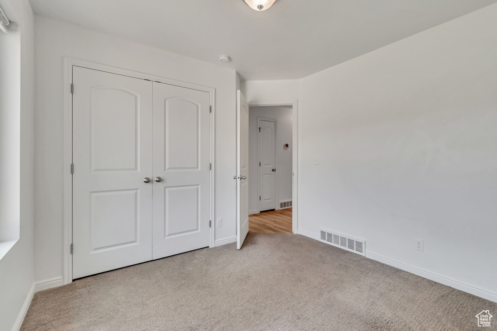 Unfurnished bedroom with carpet floors and a closet