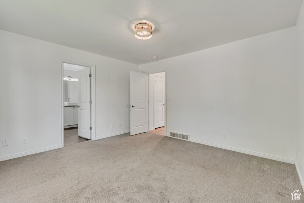 Unfurnished room featuring carpet flooring and baseboards