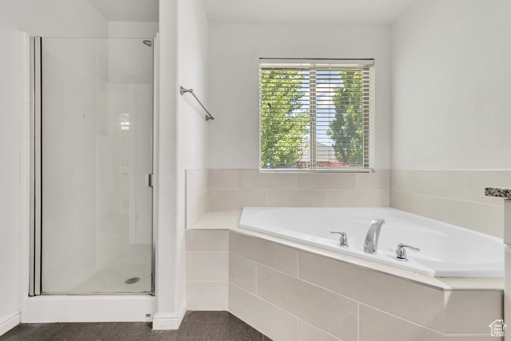 Full bathroom featuring a shower stall and a garden tub