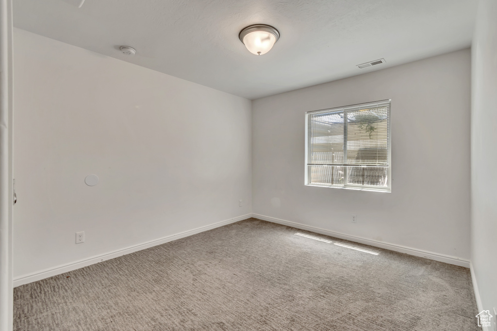 Spare room with carpet flooring and a smoke detector