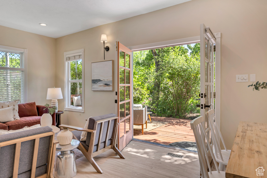 Doorway with wood finished floors and recessed lighting