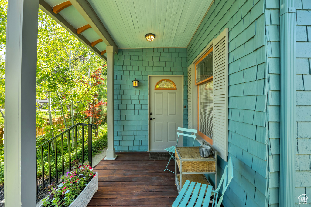Doorway to property featuring covered porch