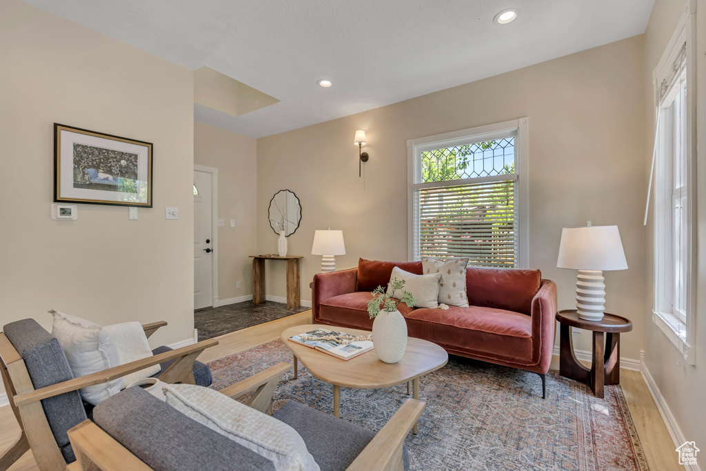Living area with wood finished floors and recessed lighting