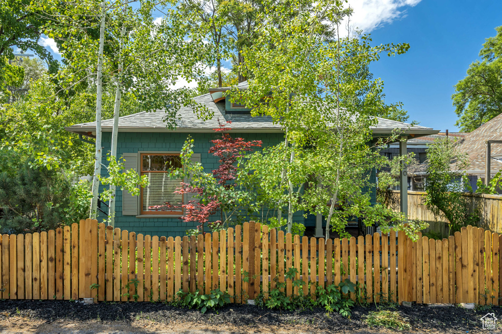 View of home\'s exterior featuring roof with shingles