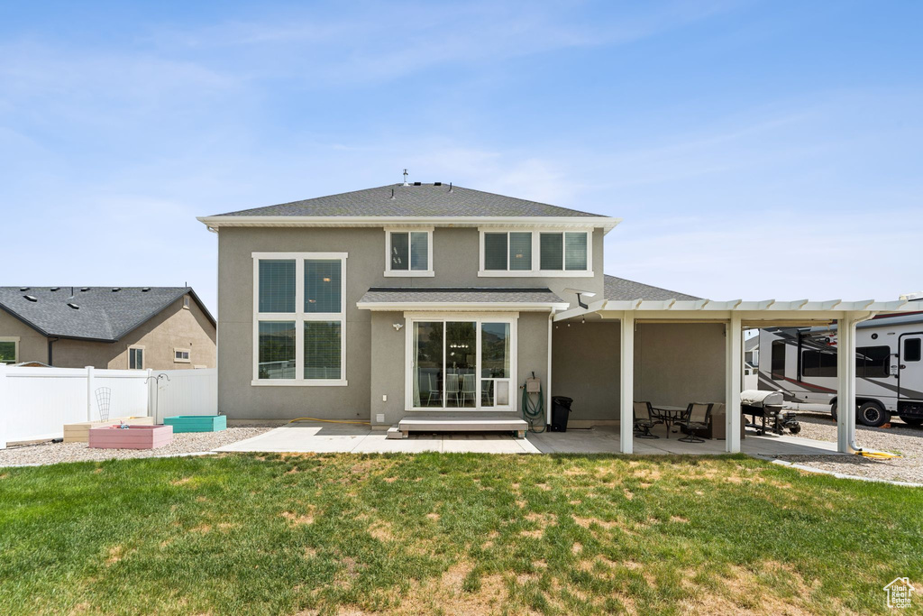 Rear view of house with stucco siding, a patio, roof with shingles, and a pergola