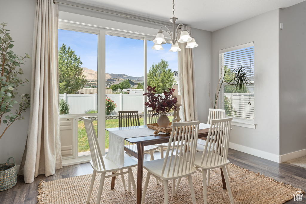 Dining area with a chandelier and wood finished floors