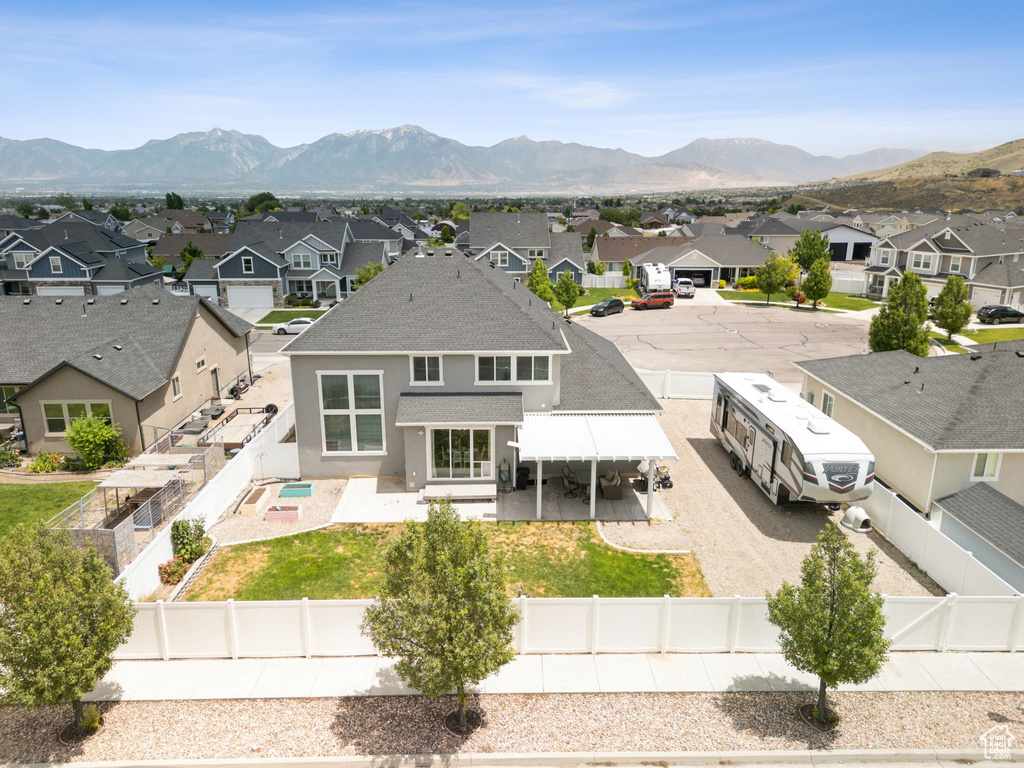 Back of property with a residential view, a fenced backyard, and roof with shingles