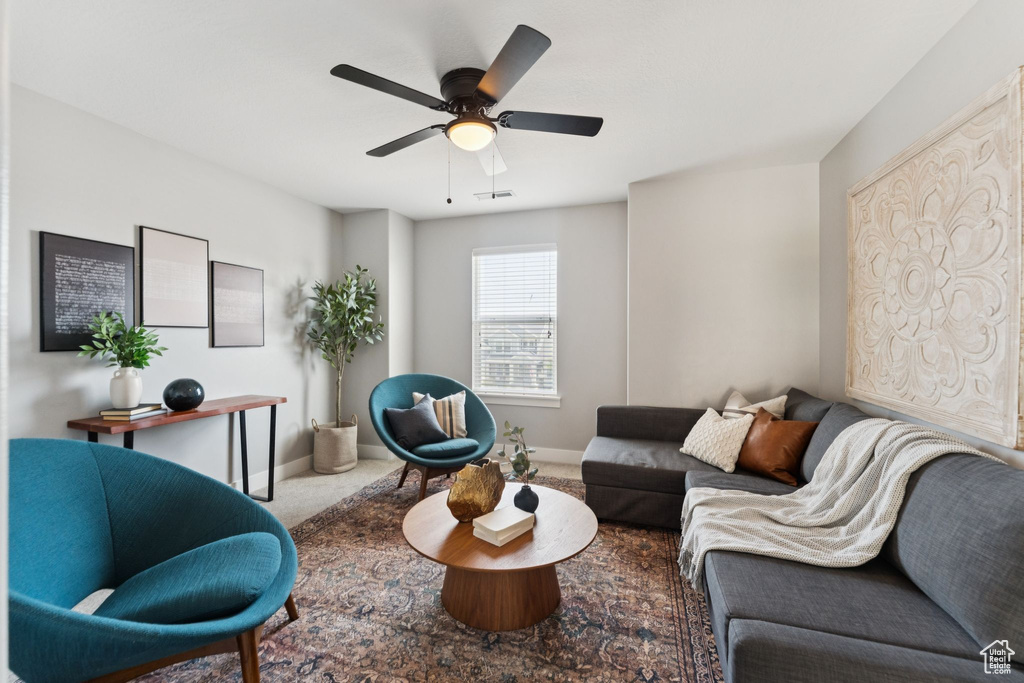 Living room featuring carpet and ceiling fan