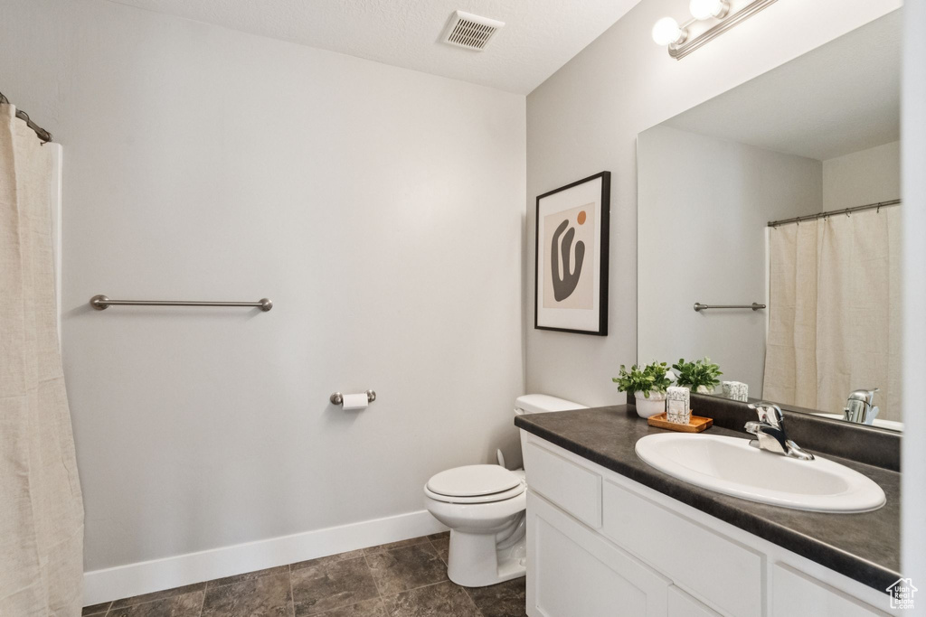 Bathroom featuring toilet and vanity