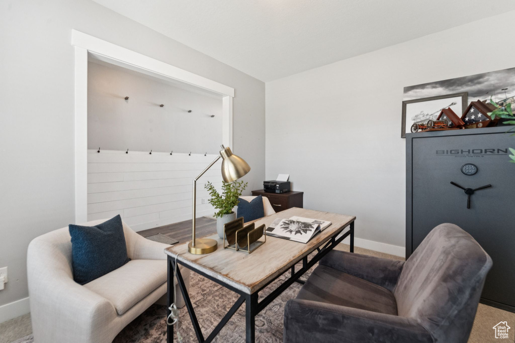 Carpeted office space with baseboards