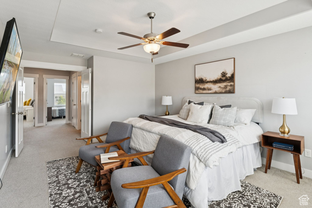 Bedroom with light carpet and ceiling fan